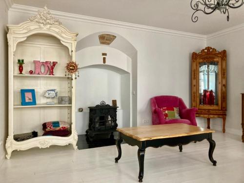 a room with a table and a chair and a mirror at Shabby Chic - apartment in the Heart of Vilnius Old Town in Vilnius
