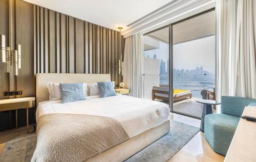 a bedroom with a bed and a view of the city at Five Palm Jumeirah Suites-Sea View in Dubai