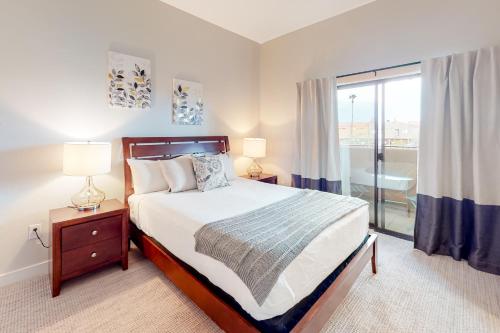 a bedroom with a bed and a window with a tub at Placita Escondida #204 in Tucson