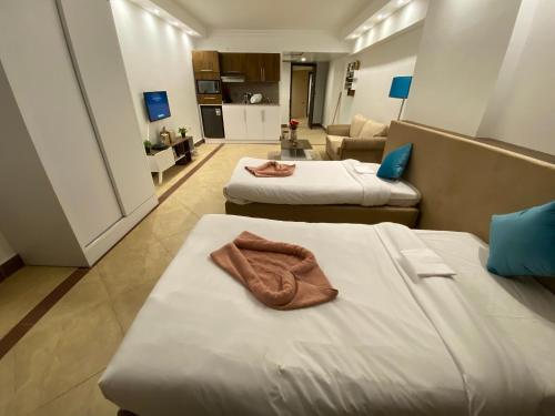 Ένα ή περισσότερα κρεβάτια σε δωμάτιο στο Alia Beach Residence