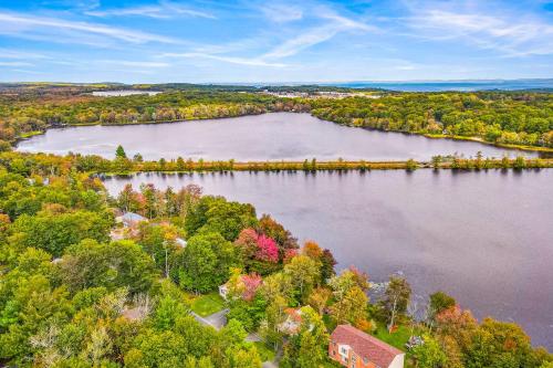 an aerial view of a lake with trees and houses at The Cabin in Pocono Summit