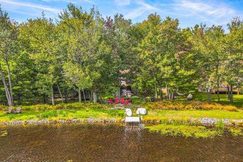 a white bench sitting in the middle of a pond at The Cabin in Pocono Summit