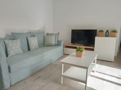 Televízia a/alebo spoločenská miestnosť v ubytovaní Las Olas 206