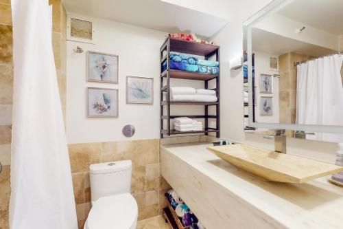 a bathroom with a sink and a toilet at Kauai Beach Resort #3124 in Lihue