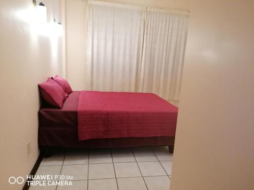 a bedroom with a bed with a pink blanket at Kingsview 201 in Margate