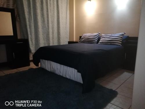 a bedroom with a bed with two pillows on it at Kingsview 201 in Margate