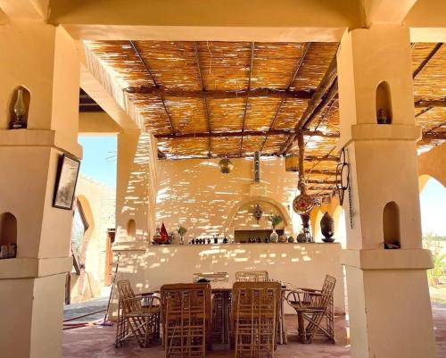 a patio with a table and chairs in a building at Hayaat siwa hot spring in Siwa