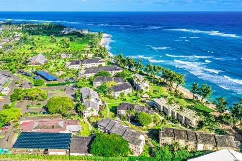 an aerial view of a beach with houses and the ocean at Islander on the Beach 333 in Kapaa