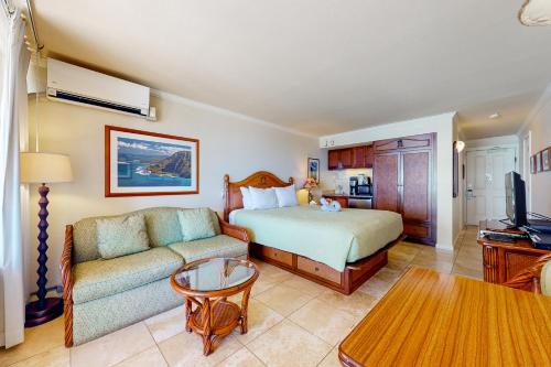 a hotel room with a bed and a couch at Islander on the Beach 353 in Kapaa