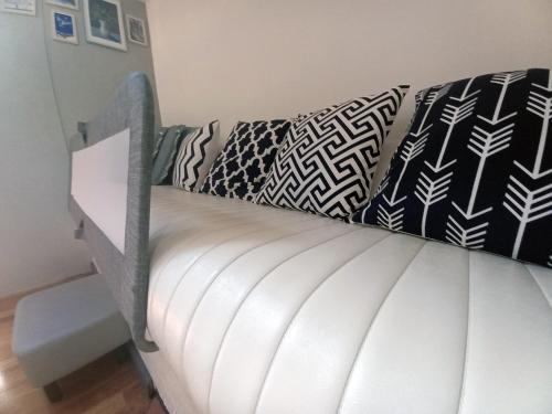 a couch with pillows on it in a room at Appartement atypique indépendant sur péniche in Metz