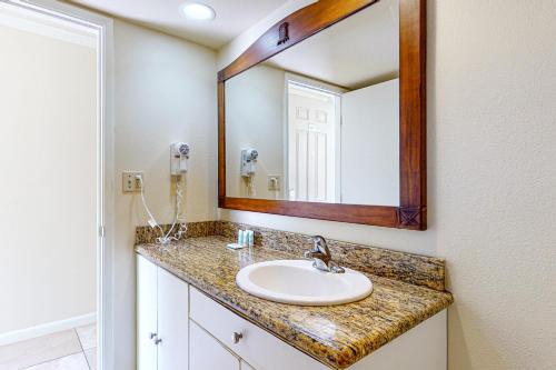 a bathroom with a sink and a mirror at Islander on the Beach 121 in Kapaa