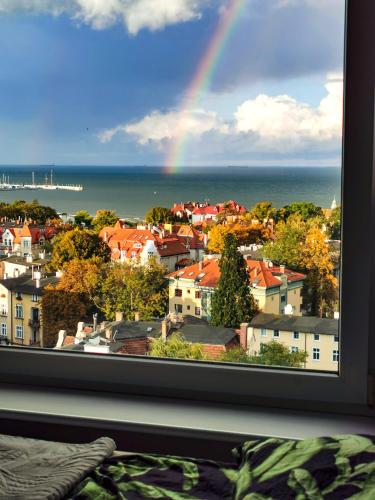 a view of a rainbow from a window at Pokoje przy plaży z widokiem na morze in Sopot