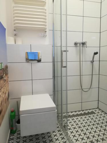 a bathroom with a shower with a toilet in it at Mirabella 1 in Kołobrzeg