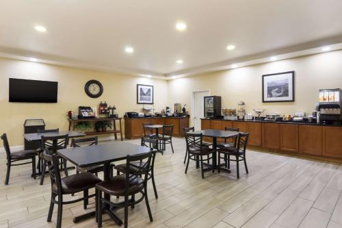 a restaurant with tables and chairs and a counter at Best Western Comanche Inn in Comanche