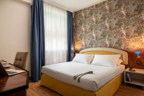 a bedroom with a bed with a floral wall at Best Western Park Hotel Roma Nord in Fiano Romano
