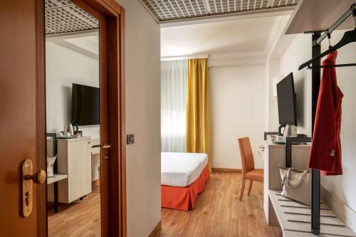 a hotel room with a bed and a desk at Best Western Park Hotel Roma Nord in Fiano Romano