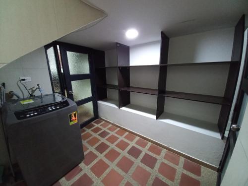 a small kitchen with a sink and a refrigerator at Apartamento amoblado en la Francia in Manizales