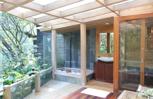 a bathroom with a tub and a sink on a deck at Silk Valley SPA Resort in Taipei