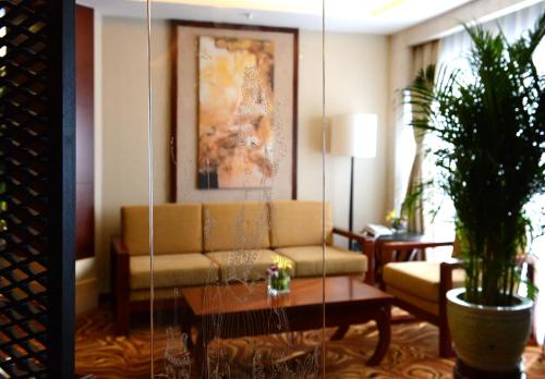 a living room with a couch and a table at Xiyuan Hotel in Beijing