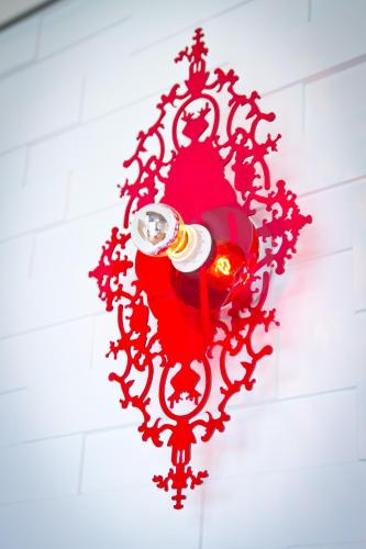 a red chandelier hanging on a wall at Muho B&B in Dongshan