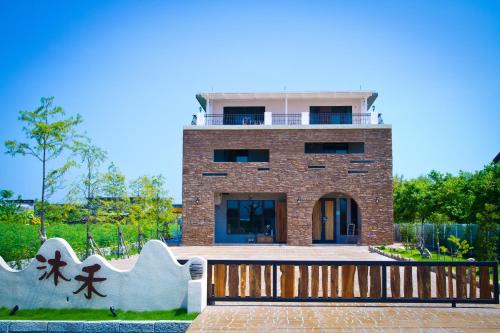 a building with a fence in front of it at Muho B&B in Dongshan