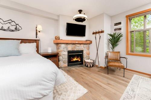 a bedroom with a bed and a fireplace at The Upper Tip, Elevate your vacation, with Hot Pool and Hot Tub in Panorama