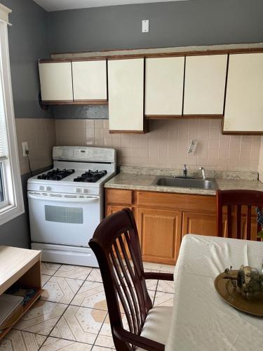 a kitchen with a stove and a sink at Home Away From Home in Wakefield