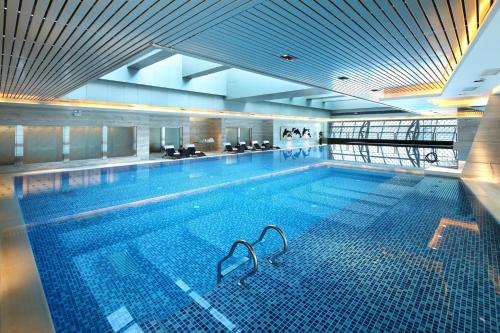 a large swimming pool in a large building at Langham Place Guangzhou - Walking distance to Canton Fair in Guangzhou