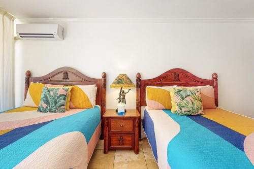 two beds sitting next to each other in a bedroom at Islander on the Beach 171 in Kapaa
