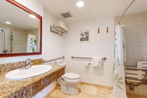 a bathroom with a sink and a toilet at Islander on the Beach 171 in Kapaa