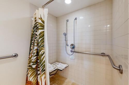 a bathroom with a shower with a shower curtain at Islander on the Beach 157 in Kapaa