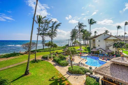an aerial view of a resort with a swimming pool and the ocean at Islander on the Beach 211 in Kapaa