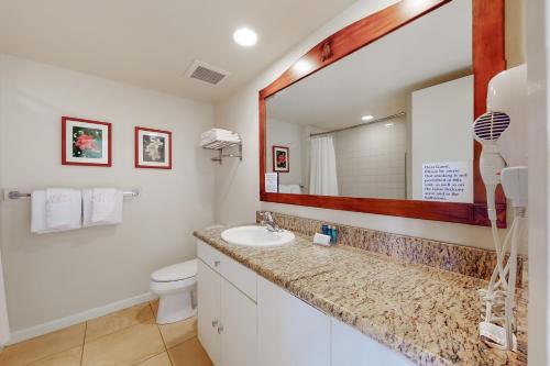 a bathroom with a sink and a mirror at Islander on the Beach 354 in Kapaa