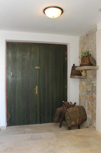 a large green door in a room with luggage at Holiday house with WiFi Kukljica, Ugljan - 8251 in Kukljica