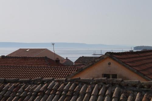 a group of roofs with the ocean in the background at Holiday house with WiFi Kukljica, Ugljan - 8251 in Kukljica