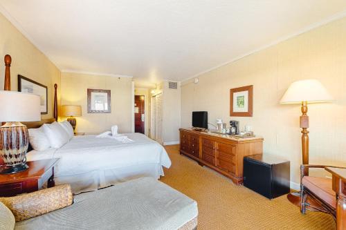 a large hotel room with a bed and a couch at Kauai Beach Resort #1317 in Lihue