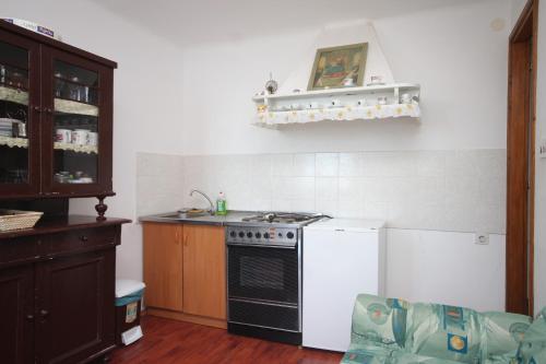 a kitchen with a stove and a white refrigerator at Apartments with WiFi Beli, Cres - 8094 in Beli