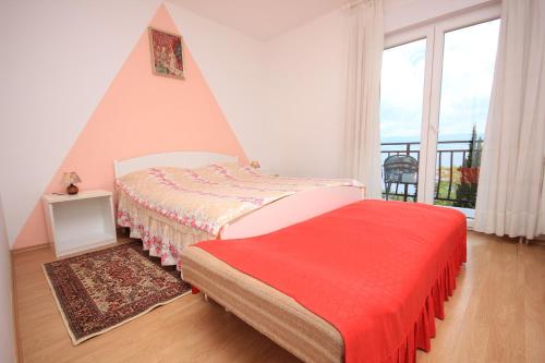 a bedroom with a bed with a red blanket at Double Room Medveja 2305a in Lovran