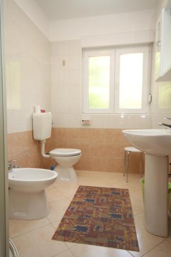 a bathroom with two toilets and a sink at Apartments with parking space Moscenicka Draga, Opatija - 2327 in Mošćenička Draga