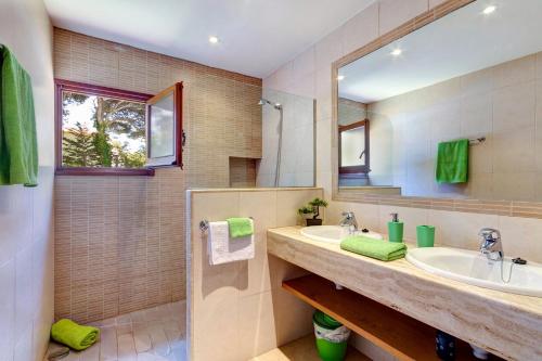 a bathroom with a sink and a mirror at Villa Pinar by Villa Plus in Ferreries