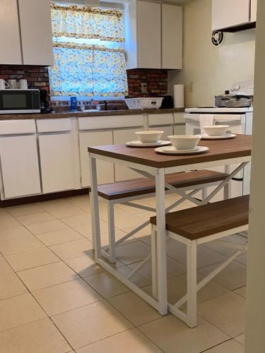 a kitchen with a table and a table and chairs at Spacious 3bedroom free wine,WiFi,and parking in Milwaukee