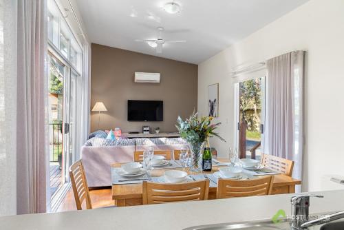 a dining room and living room with a table and chairs at Rural 5 Star Villa's with Resort Amenities in Cowes