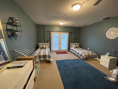 a bedroom with two beds and a room with a window at Hakuna Matata Hostel Shared Room in Charlotte