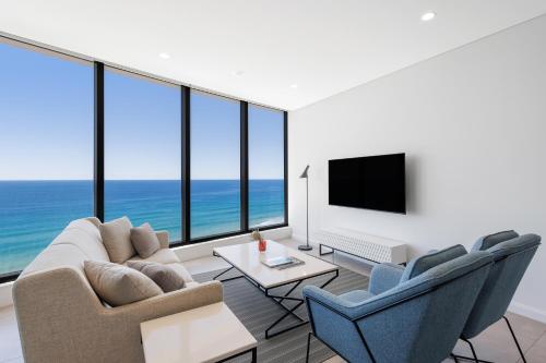 a living room with a view of the ocean at Meriton Suites Surfers Paradise in Gold Coast
