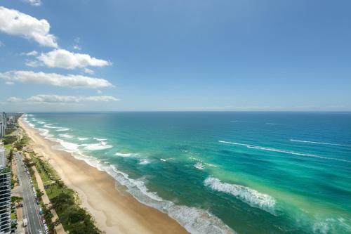 an aerial view of the ocean and a beach at Meriton Suites Surfers Paradise in Gold Coast