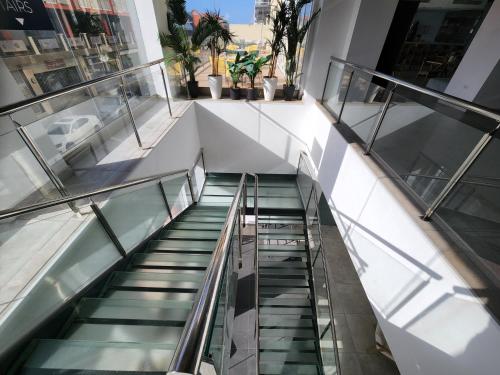 an escalator in a building with escalators andwindows at ARUBA DREAM GETAWAY 2BR/2BT OCEAN & POOL VIEW in Oranjestad