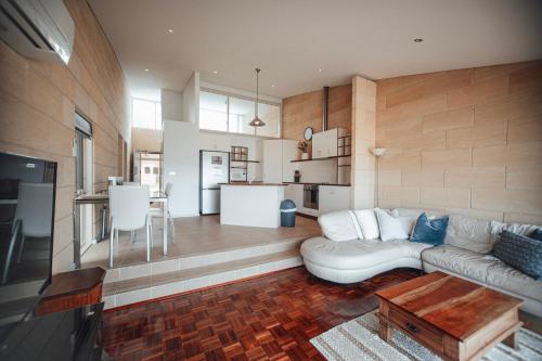 a living room with a white couch and a kitchen at Bayview no 2 in Port Campbell