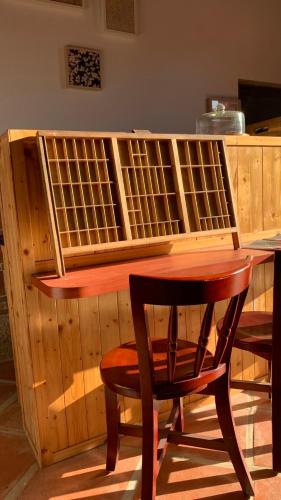 a wooden desk with a wooden chair and a table at Yamaharuka Historic House in Jinhu