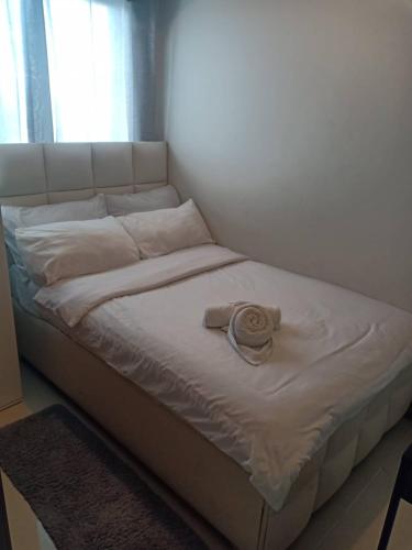 a bed in a room with a pillow on it at StayInMyCondo - 30th Condo in Pasay with Pool near Airport MOA,CCP & PICC In Pasay in Manila