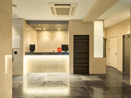a lobby with a reception desk in a building at Tabist Ginza in Tokyo